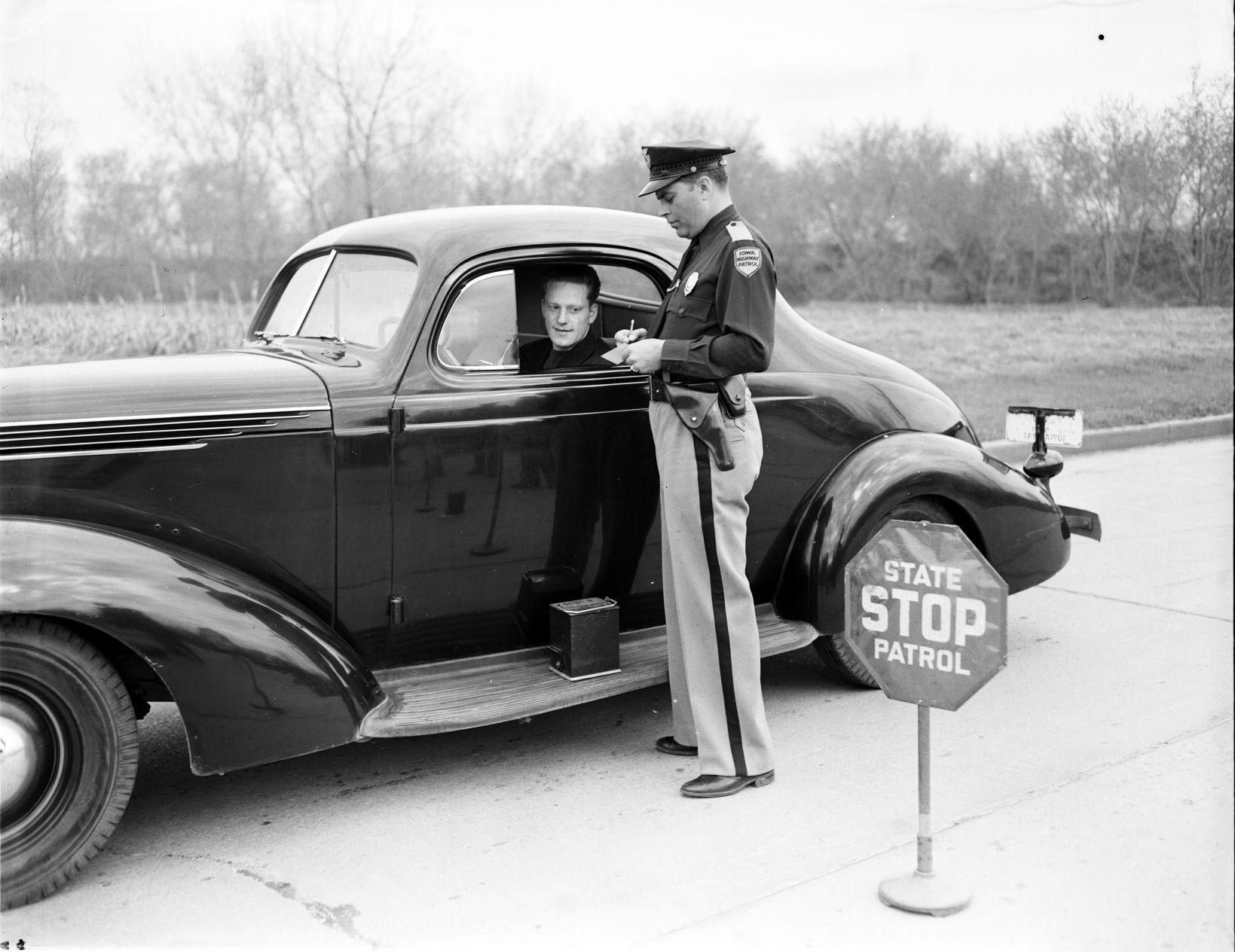 Highway patrolman checking brakes